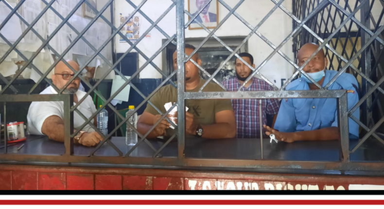 Omar Shallo, the United Democratic Alliance (UDA) candidate for the Mvita Parliamentary seat (middle) and Tudor ward MCA candidate Samir Bhalo in police custody at the Makupa police station.