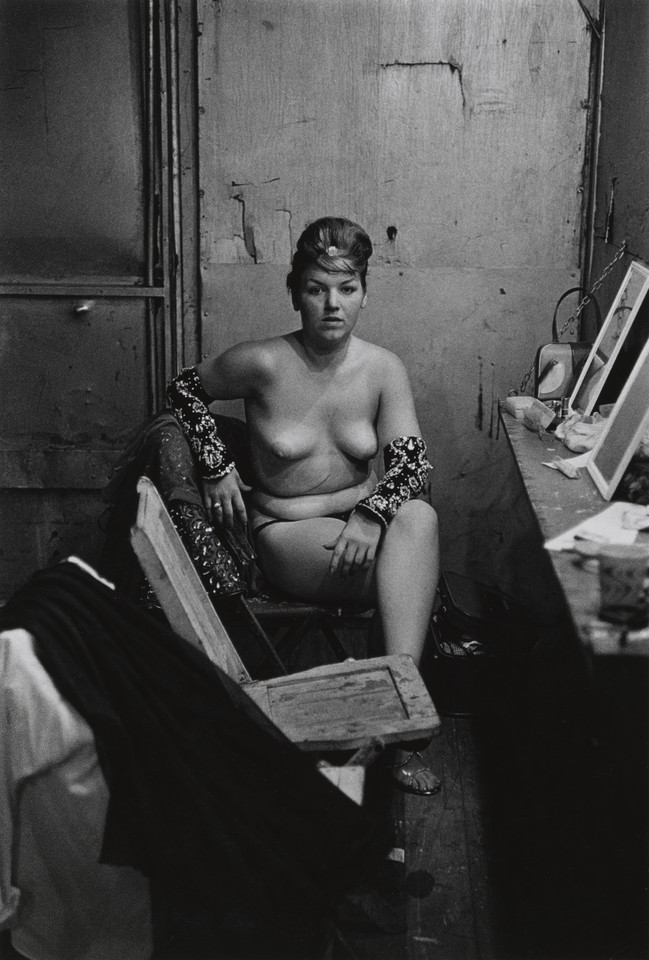 Diane Arbus, "Stripper with bare breasts sitting in her dressing room" (Atlantic City, N.J., 1961)