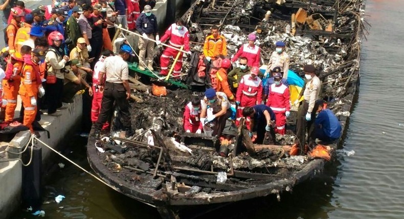 Rescuers search a charred remains of a passenger boat after it caught fire while ferrying around 200 people off the coast of Jakarta to Tidung island, a tourist destination 50 kilometres (30 miles) from the capital on January 1, 2017