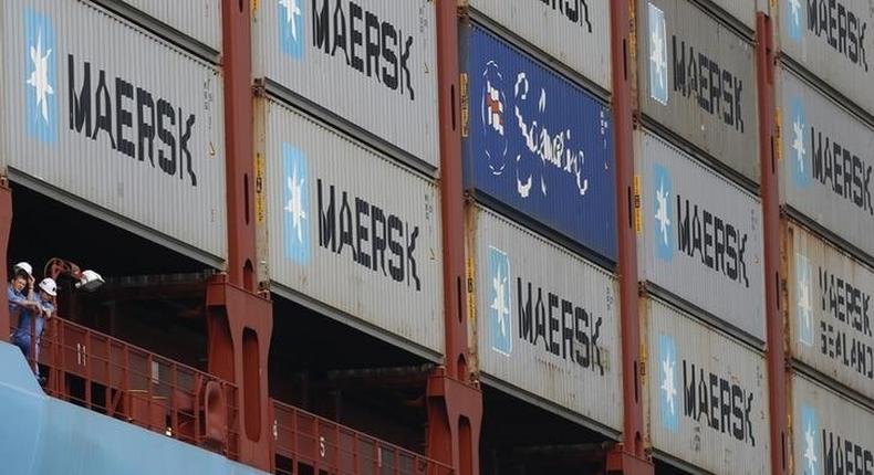 Crew members look out from the world's largest container ship, the MV Maersk Mc-Kinney Moller, as it berths during its maiden port of call at a PSA International port terminal in Singapore September 27, 2013. REUTERS/Edgar Su
