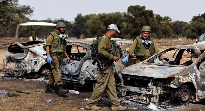 Israel soldiers inspect burnt cars at the site of the Hamas terrorist attacks on the Nova music festival in southern Israel.Amir Cohen/Reuters