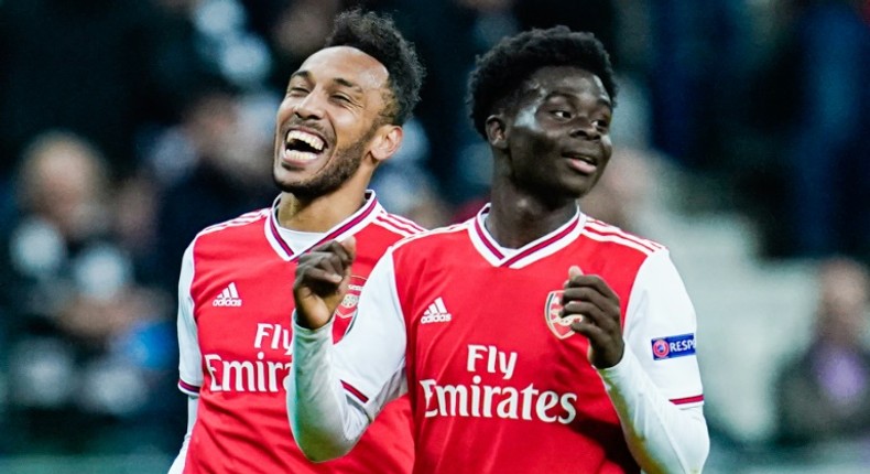 Arsenal striker Pierre-Emerick Aubameyang (L) and teenage forward Bukayo Saka celebrate after scoring scoring during the Europa League win at Eintracht Frankfurt on Thursday