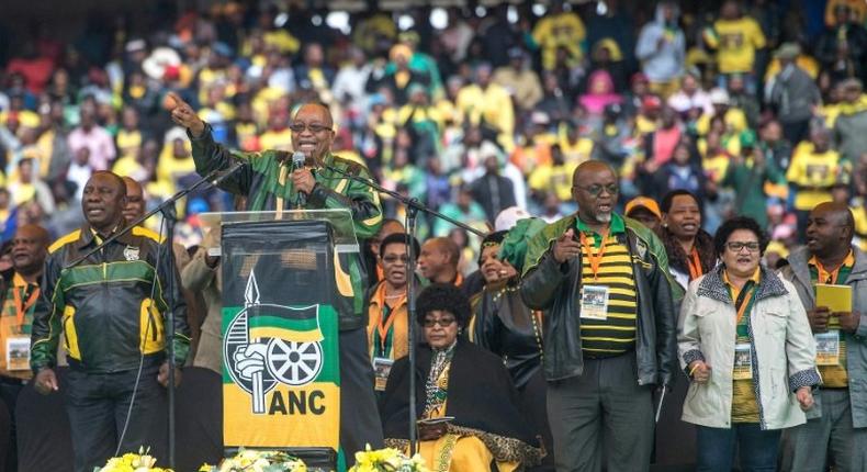 South African President Jacob Zuma delivers a speech on stage at Orlando Stadium in Soweto on January 8, 2017