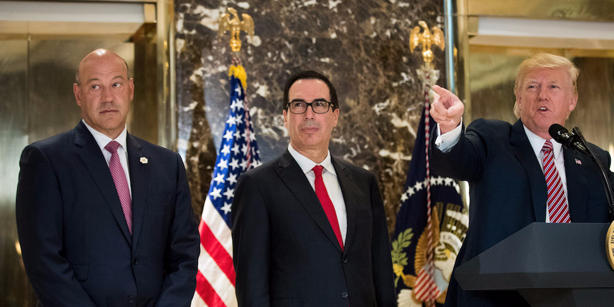Top White House economic adviser Gary Cohn and Treasury Secretary Steven Mnuchin look on as Trump answers reporters' questions about his reaction to the white supremacist rally in Charlottesville last month.