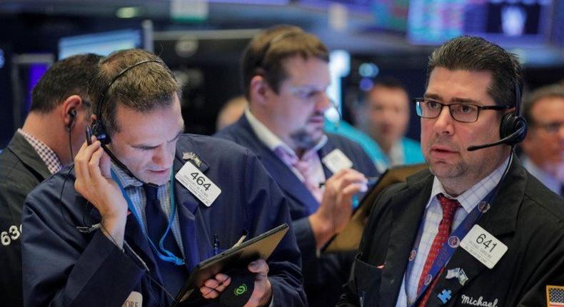 FILE PHOTO: Traders work on the floor at the New York Stock Exchange (NYSE) in New York, U.S., January 10, 2020. REUTERS/Brendan McDermid