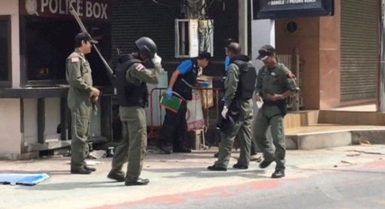 Officials investigate at the scene of bomb blasts in the tourist beach town of Patong on Phuket island, Thailand in this still image from video August 12, 2016. 