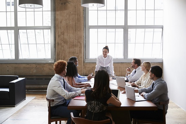 Business colleagues at meeting looking to female manager