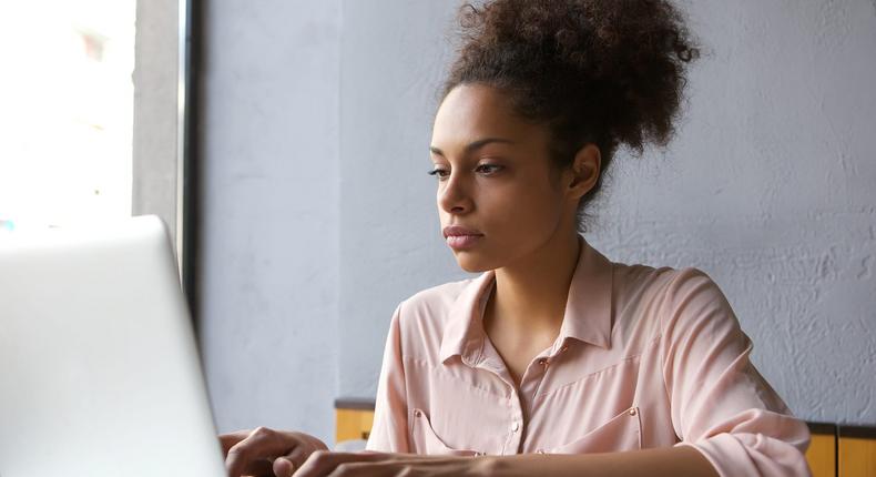 Woman searching email on laptop