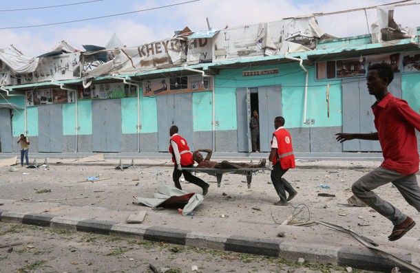 Rescuers carry an unidentified injured man from the scene of an explosion in front of Dayah hotel in