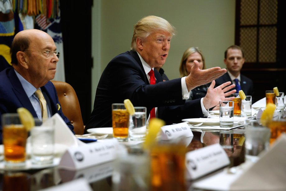 U.S. President Donald Trump and his Commerce Secretary nominee Wilbur Ross (L) meet with representatives of Harley-Davidson at the White House in Washington, U.S. February 2, 2017.