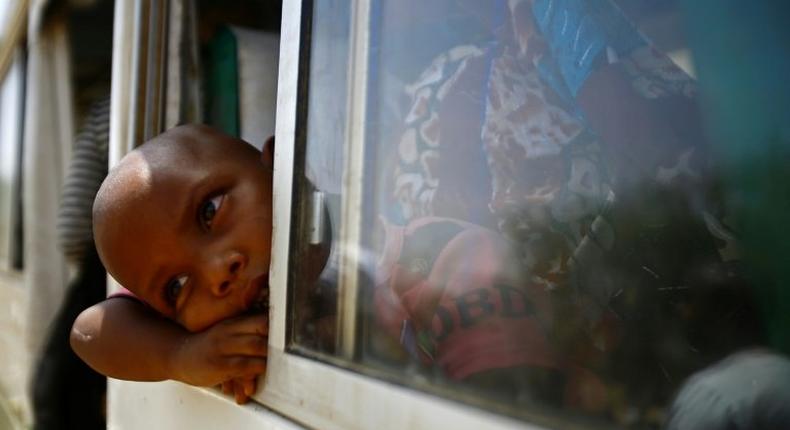 Migrants from Eritrea sit on a bus at the al-Laffa border crossing in Sudan's eastern Kassala state on the Eritrea-Sudan border on May 2, 2017