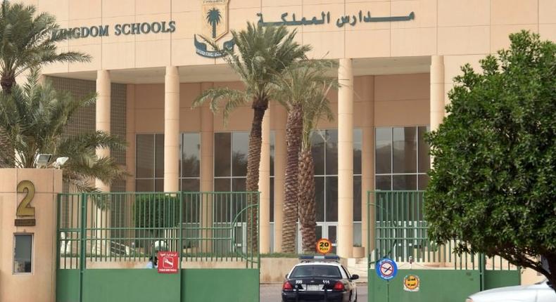 A police car passes through the main entrance of the Kingdom School in Riyadh on May 31, 2017