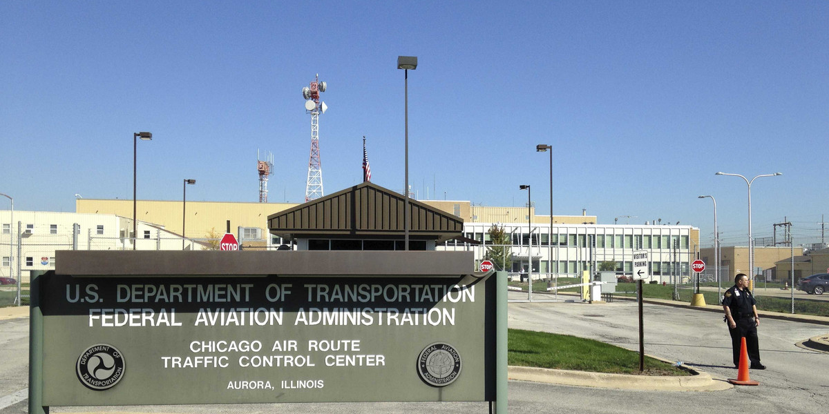 A police officer stands guard outside the FAA air traffic control center in Aurora, Illinois.