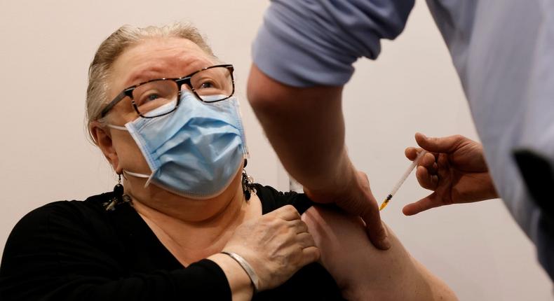 A pharmacist administers the AstraZeneca COVID-19 vaccine to a patient in a pharmacy in Roubaix as part of the coronavirus disease (COVID-19) vaccination campaign in France, March 15, 2021.
