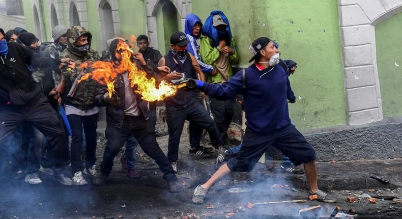 Demonstrators clash with riot police in Quito. The protestors are demanding the president reinstate fuel subsidies which were cut last week