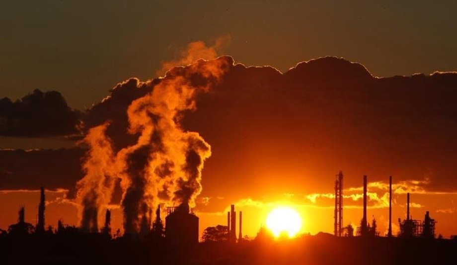 Steam and other emissions are seen coming from funnels at a chemical manufacturing facility.