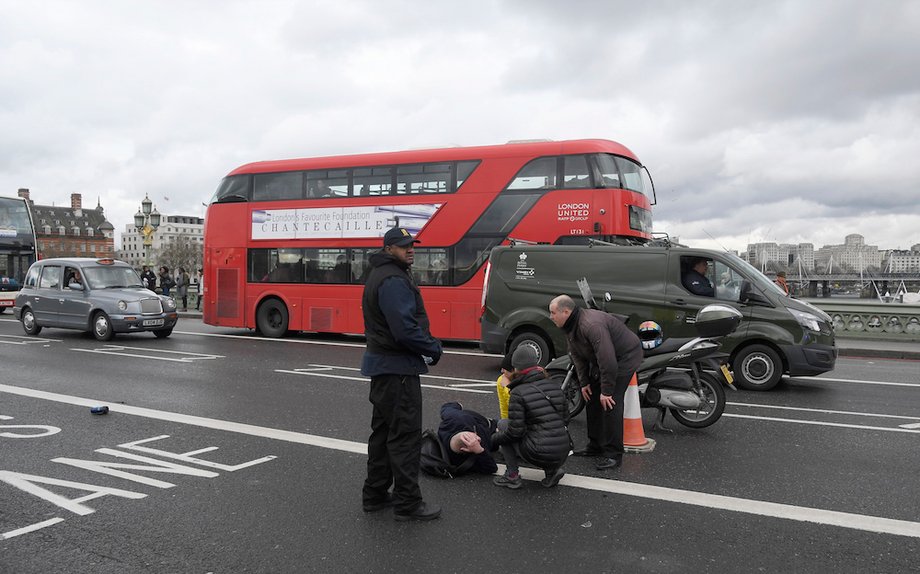 A man lies injured after a shottingt incident on Westminster Bridge in London, March 22, 2017.