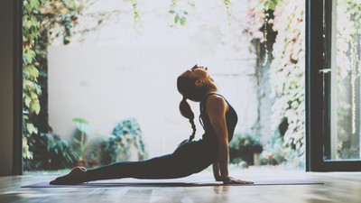 Portrait of gorgeous young woman practicing yoga indoor. Beautiful girl