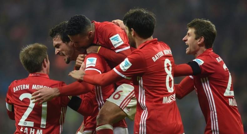 Bayern Munich's defender Mats Hummels (2nd L) celebrates scoring with his teammates during the German first division Bundesliga football match against Bayer 04 Leverkusen November 26, 2016