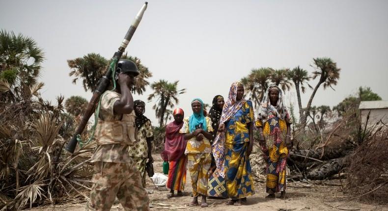 A Nigerian soldier patrols on the outskirts of Damasak in northeastern Nigeria as peace returns after years of trouble from Boko Haram insurgents