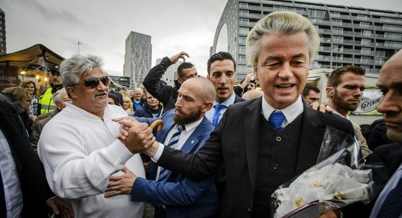 Dutch right-wing politician Geert Wilders (2nd R) of the Freedom Party (PVV) shakes hands with supporters during a protest against emergency accommodation for refugees in Rotterdam, in 2015