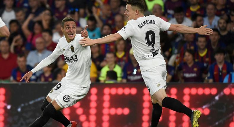 Rodrigo (L) and Kevin Gameiro got the goals as Valencia upset Barcelona in Seville