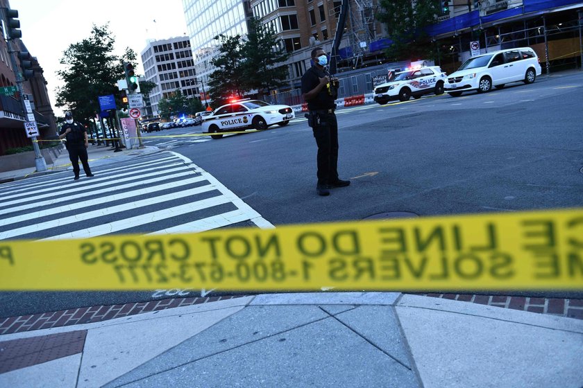 Police officers stop a suspect after a shooting incident outside of the White House, in Washington