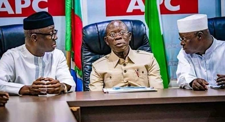 APC national chairman, Adams Oshiomhole, flanked by party men. 