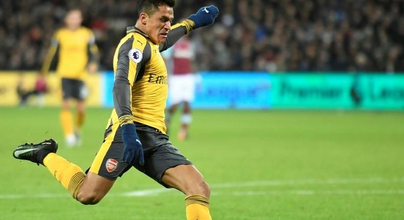 Arsenal's Alexis Sanchez shoots to score the team's second goal during the match against West Ham United in east London on December 3, 2016