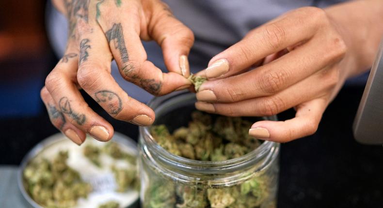 A budtender weighs out marijuana for a customers at ShowGrow, a medical marijuana dispensary in downtown Los Angeles.