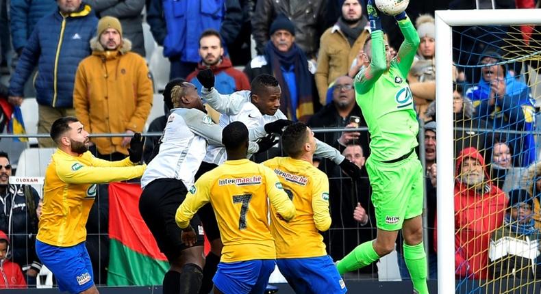 No joy for JS Saint-Pierroise of Reunion Island as Epinal goalkeeper Jerome Idir keeps them at bay in the French Cup