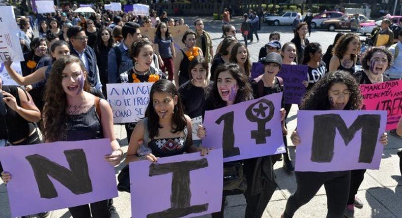 Women in Mexico City take part on October 19, 2016 in a march in solidarity for the brutal killing of a 16-year-old girl in Argentina