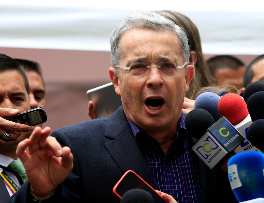 Colombia's former president, Alvaro Uribe, speaks to the media after casting his vote in Bogota, June 15, 2014.