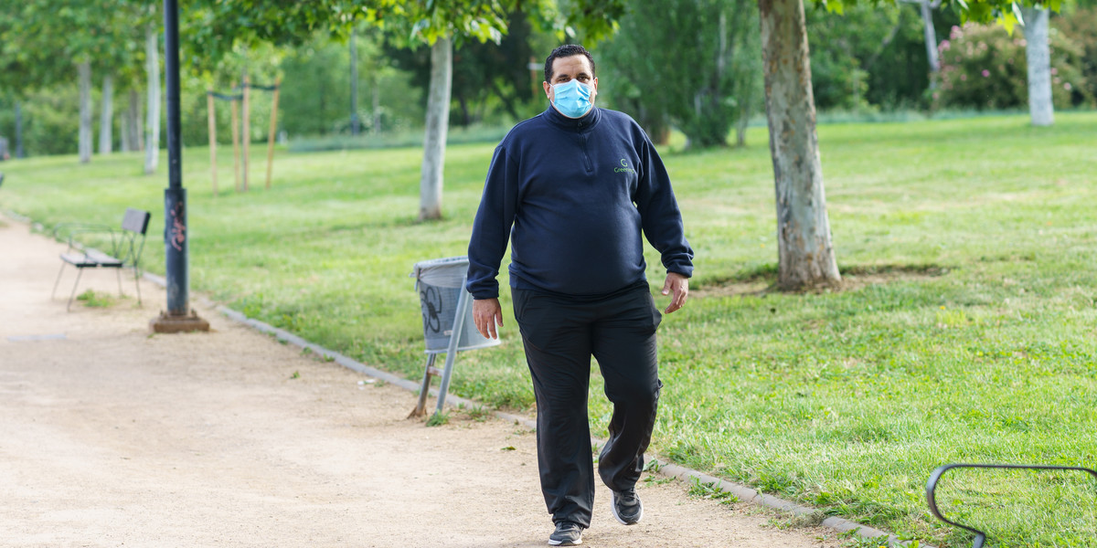 Fat man walking outdoors during the Covid-19 pandemic