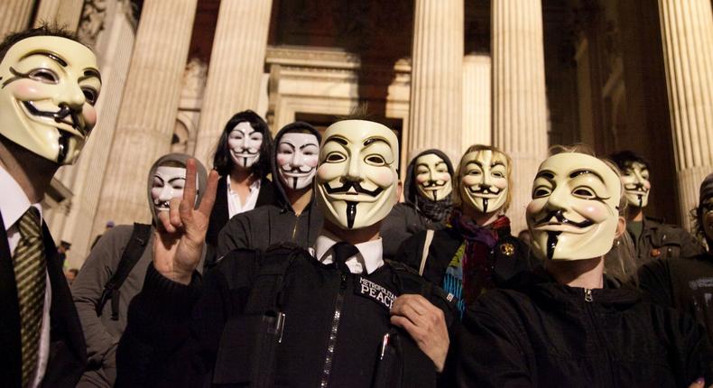 Masked up members of Anonymous.