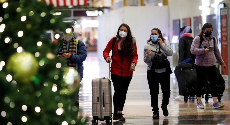 Holiday travelers wearing face masks are seen at Ronald Reagan Washington National Airport in Arlington, Virginia, the United States, on Dec. 23, 2020.