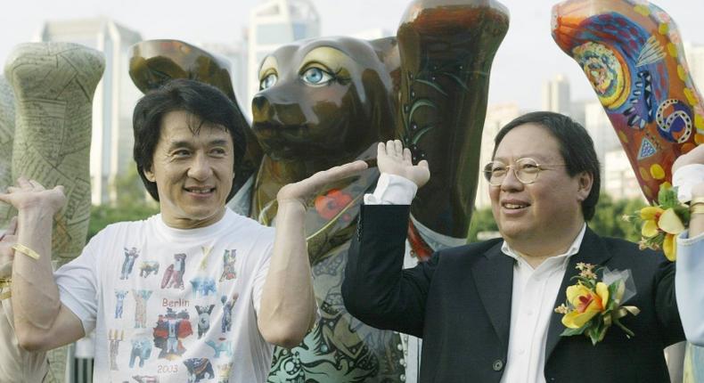 Former Hong Kong home affairs secretary Patrick Ho Chi Ping (R), pictured in a 2003 photograph with movie star Jackie Chan, was sentenced to three years in prison over a bribery scheme