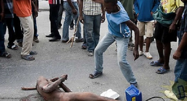 A suspected robber being given the jungle justice treatment