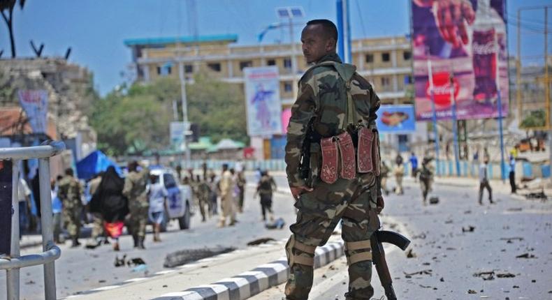 Somali security forces guard the site of a suicide blast in Mogadishu in August 2016