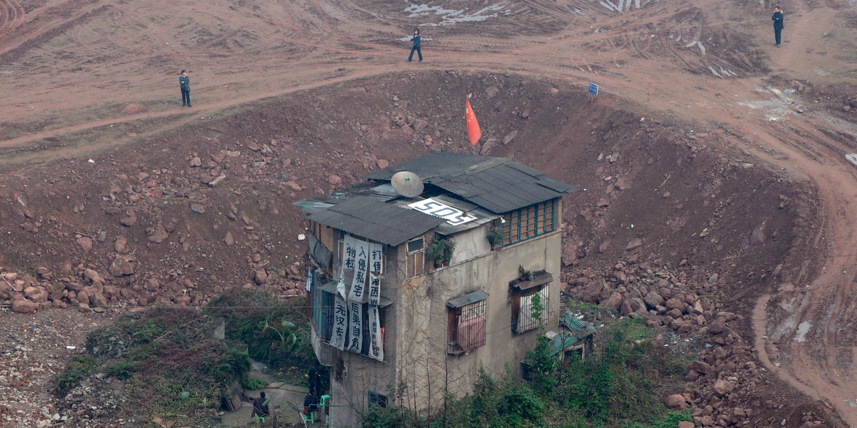 A nail house, the last house in this area, stands in the centre of a construction site that will be developed as a new apartment zone in Chongqing Municipality.