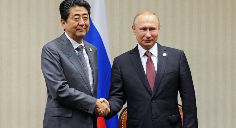 Russian President Vladimir Putin (right) and Japanese Prime Minister Shinzo Abe will hold talks to resolve the countries' dispute over the Kuril islands