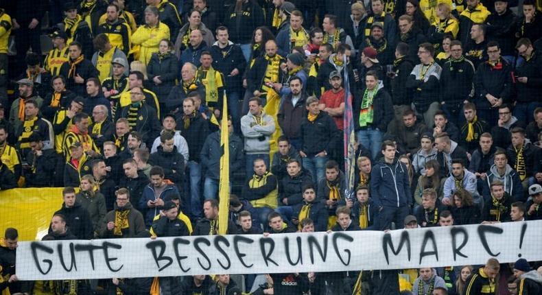 Fans hold a banner reading Get well Marc ahead the UEFA Champions League 1st leg quarter-final football match BVB Borussia Dortmund v Monaco in Dortmund, western Germany on April 12, 2017