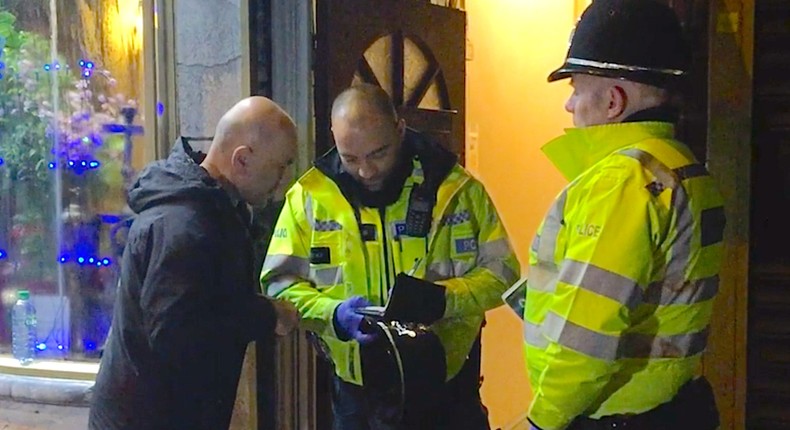 Police guard a door during a raid on a Birmingham address connected to the investigation of the Westminster Bridge attacks.