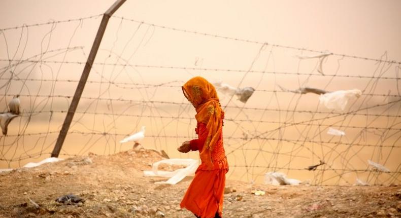 Monitors says more civilians are dying in US air strikes under President Donald Trump, particularly near the IS stronghold of Raqa. The Pentagon disputes that. A woman who was among Syrians who fled Raqa is seen here at a temporary camp