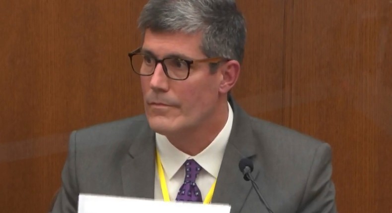 In this image from video, Dr. Andrew Baker, Hennepin County Medical Examiner, testifies as Hennepin County Judge Peter Cahill presides Friday, April 9, 2021, in the trial of former Minneapolis police Officer Derek Chauvin at the Hennepin County Courthouse in Minneapolis, Minn. Chauvin is charged in the May 25, 2020 death of George Floyd.
