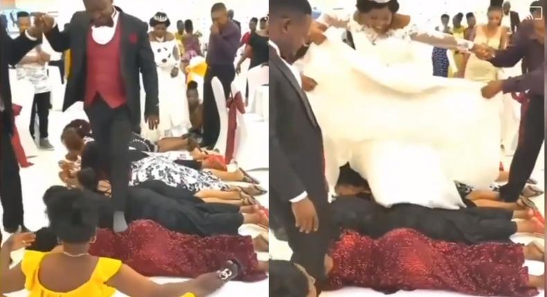 Bride and groom walk on the backs of guests at their wedding reception (video)