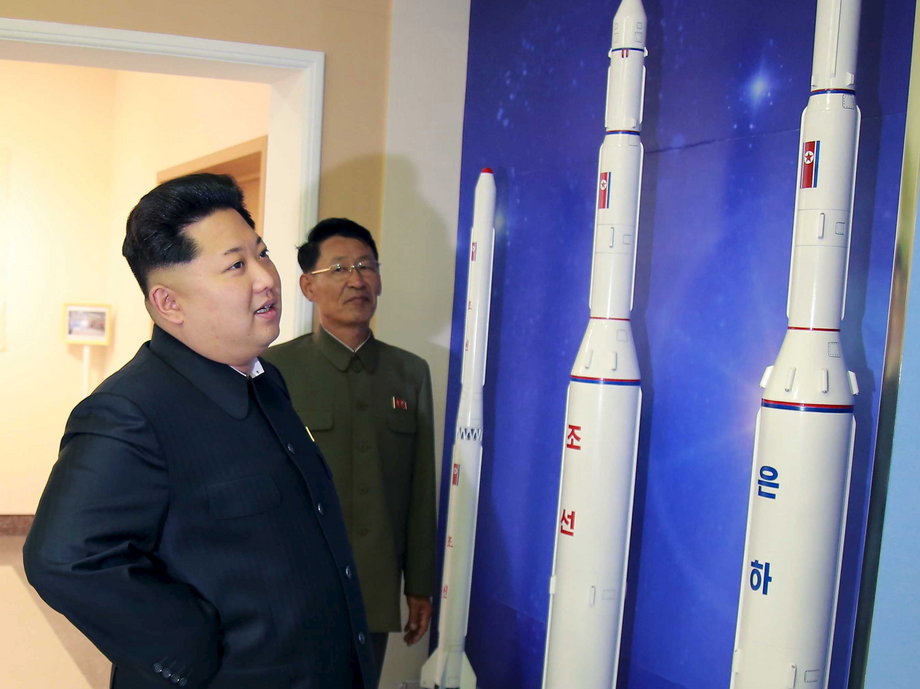 North Korean leader Kim Jong Un looks at newly built rockets in this undated photo released by KCNA.