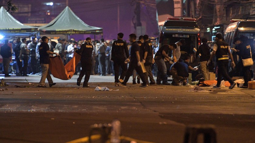 Police secure the area following an explosion at a bus stop in Kampung Melayu, East Jakarta, Indones