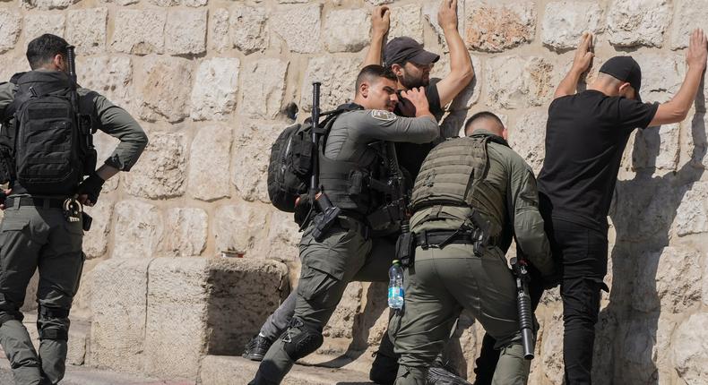 Israeli security forces conduct a security check on Palestinians outside Jerusalem's Old City.AP Photo/Mahmoud Illean