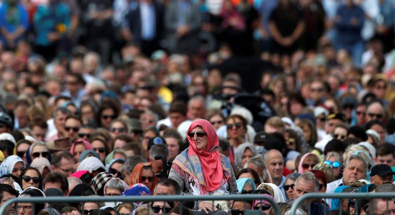 People attend the Friday prayers at Hagley Park outside Al-Noor mosque in Christchurch